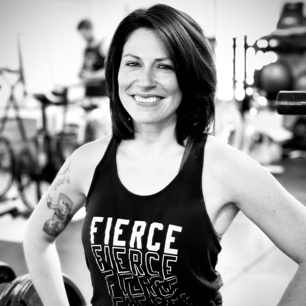 Portrait of Lyndsey smiling and confident wearing a shirt that says 'fierce'